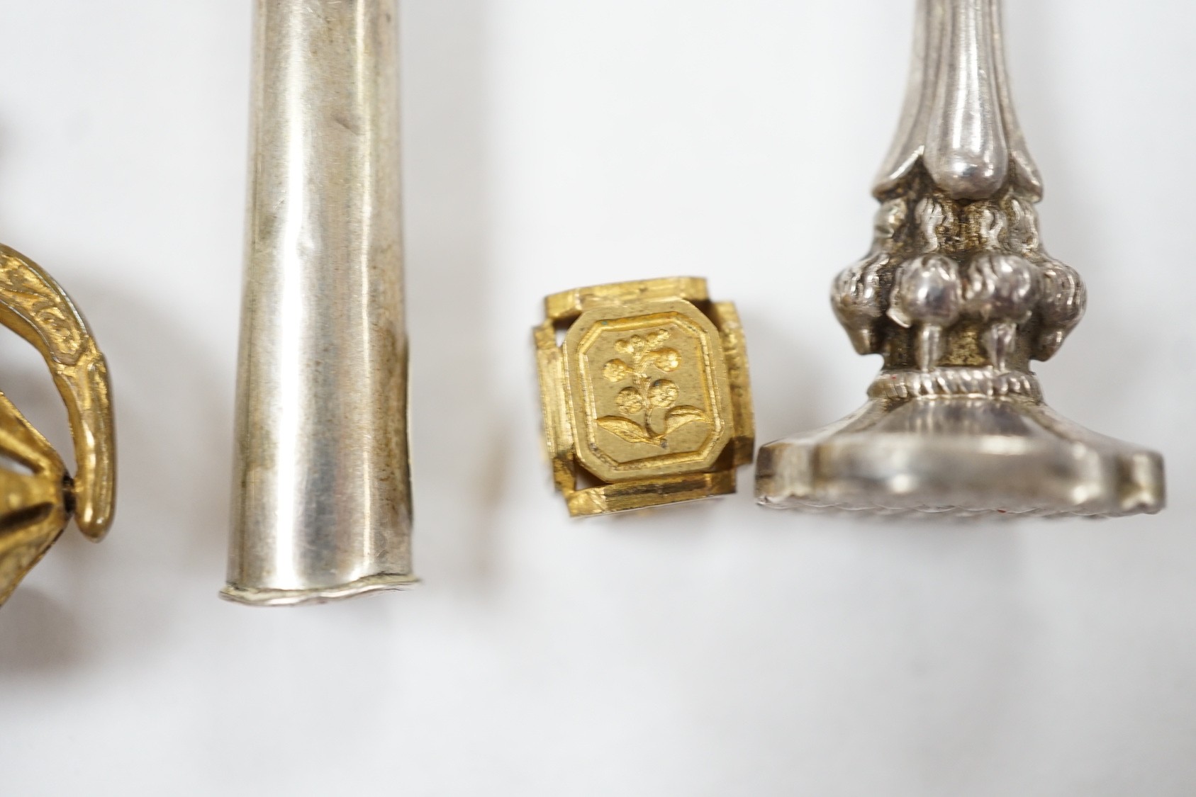 A group of twenty-five steel, gilt metal or nickel fob or desk seals, mostly 19th-century, including a steel swivel seal, a seal with boxwood finial modelled as a hand holding a ball and a nickel multi seal